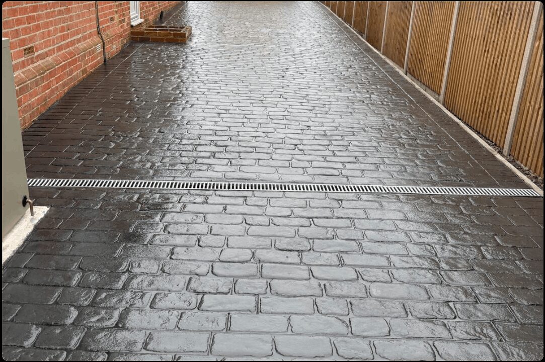 Grey block paving with planted border
